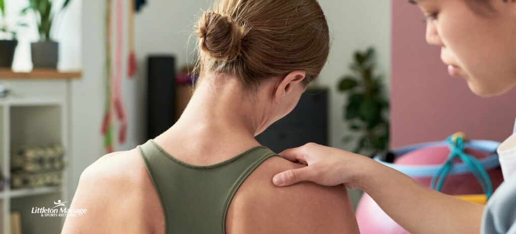 Therapist applying deep tissue massage to the shoulder to relieve muscle tension and support recovery from shoulder pain.