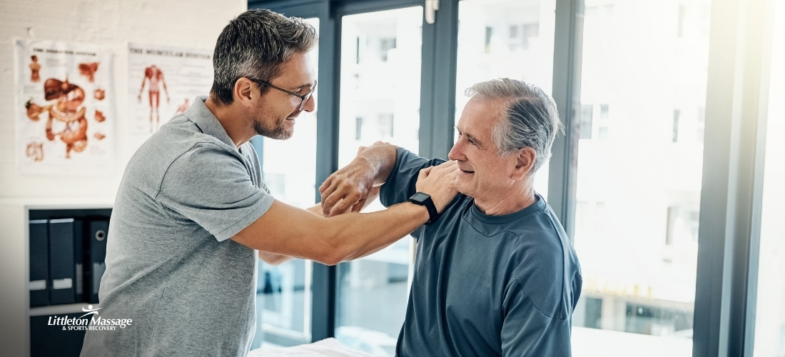 Therapist assessing an older client's shoulder mobility, illustrating how massage for arthritis in the hands and joints can aid recovery. This image is attached to a blog around is massage good for arthritis?